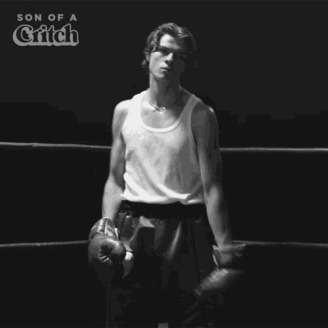a man wearing boxing gloves is in a boxing ring with the words son of a critch above him