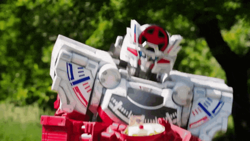 a toy robot is eating a bowl of food in a park .