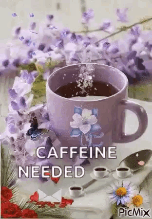 a cup of coffee is sitting on a table with flowers and butterflies .