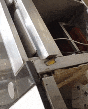 a stainless steel item with a yellow sticker that says ' a ' on it