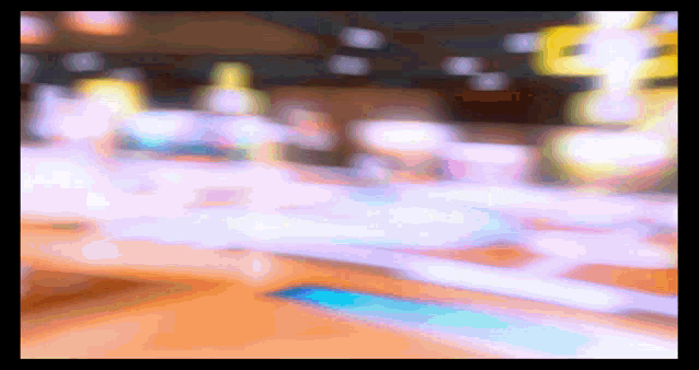 a blurry picture of a bowling alley with a blue stripe on the floor .