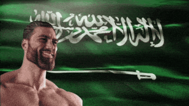 a man with a beard stands in front of a green flag