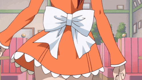 a girl in an orange dress with a white bow on her waist