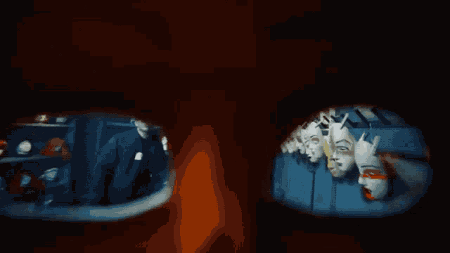a group of masks are hanging on a wall in a room
