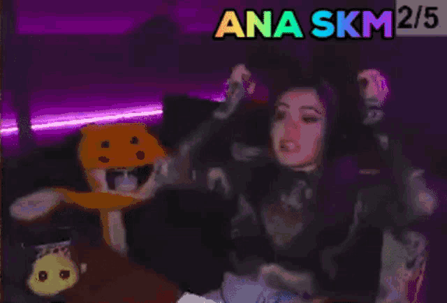a woman is sitting on a couch with her arms in the air and the words ana skm written on the bottom