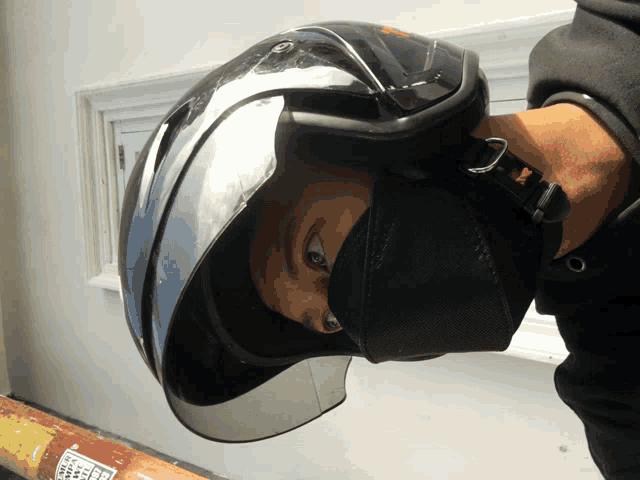 a person wearing a helmet with a sticker on the wall that says ' safety ' on it