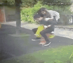 a man is carrying a woman on his back on a seesaw