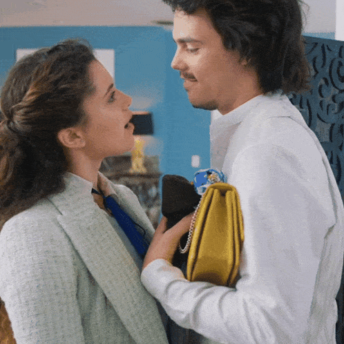 a man and a woman are looking at each other