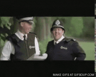 a couple of police officers are standing next to each other and smiling