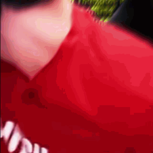 a close up of a person wearing a red shirt that says supreme