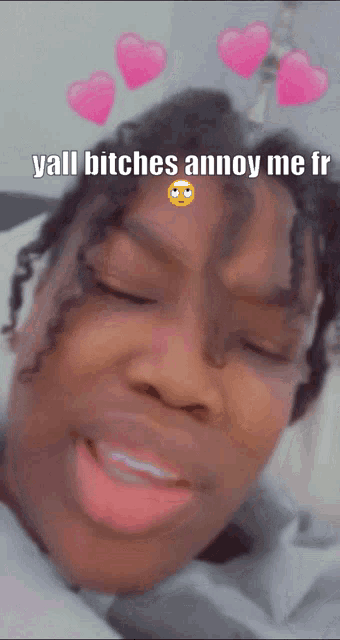 a woman with her eyes closed and hearts on her head says yall bitches annoy me fr