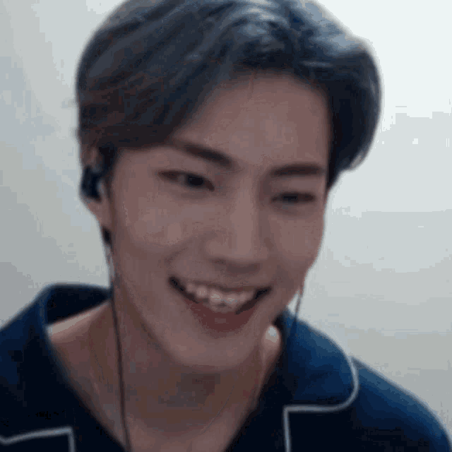 a close up of a person wearing headphones and smiling