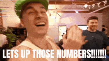 a man in a green hat laughs with the words lets up those numbers