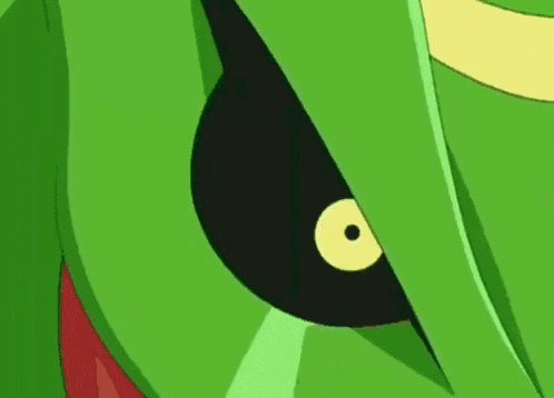 a green cartoon character with a blue sphere in its mouth