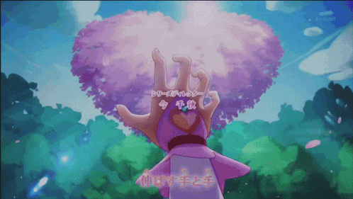 a person holding a heart in front of a cherry blossom tree with japanese writing