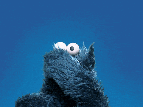 cookie monster from sesame street looks up at the sky with his mouth open