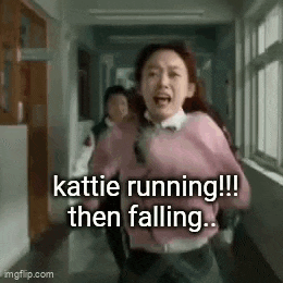 a girl in a pink sweater is running down a hallway in a school .