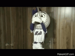 a mets mascot is holding a baseball in his mouth .