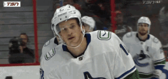 a hockey player wearing a white jersey with the number 1 on it
