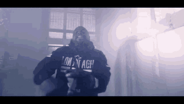 a man wearing a black hoodie that says low tach