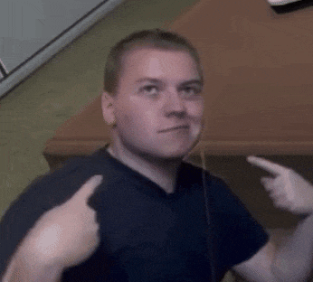 a man in a black shirt is giving a thumbs up sign .