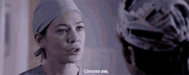 a woman in a surgical cap is talking to another woman and says choose me