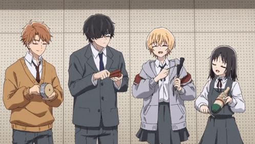 a group of people standing next to each other holding objects