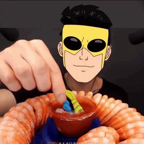 a man wearing a yellow mask is dipping shrimp in sauce