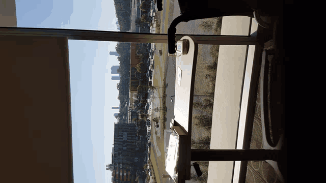 a view of a city from a hotel room with a table in the foreground