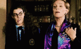 two women are standing next to each other and one is wearing a purple scarf
