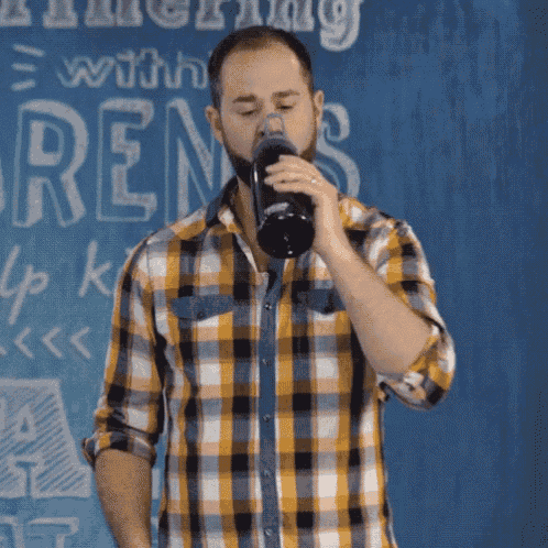 a man in a plaid shirt is brushing his teeth in front of a sign that says " nothing with ren "