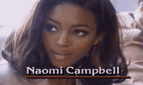 a close up of a woman 's face with the name naomi campbell written on it .