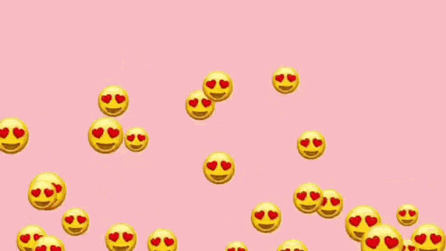 a pink background with yellow smiley faces with red hearts