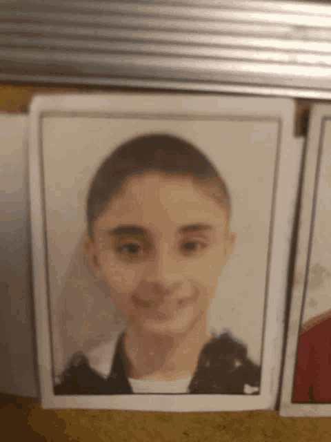 a picture of a young boy is on a table