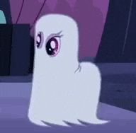 a white ghost with big eyes is sitting on the ground .
