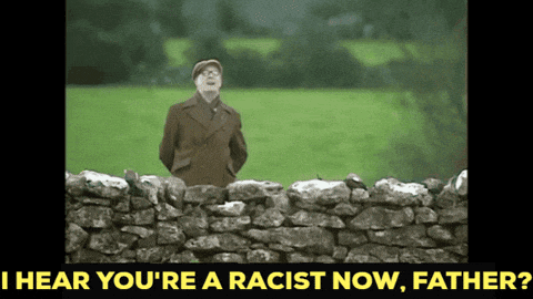 a man standing over a stone wall with the words " i hear you 're a racist now father "