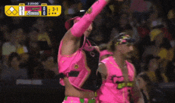 a man in a pink cowboy hat stands in front of a scoreboard that says 3 to 1