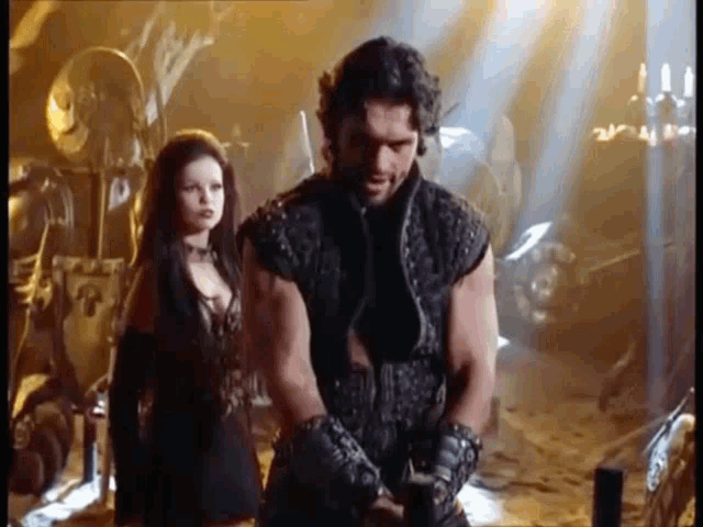 a man and a woman are standing next to each other in a room .