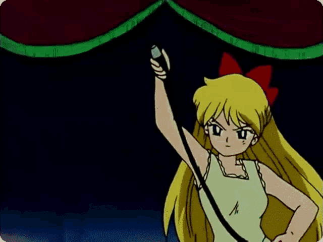 a girl with blonde hair and a red bow on her head is pointing