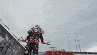 a robot is flying through the air with a large sword in the background