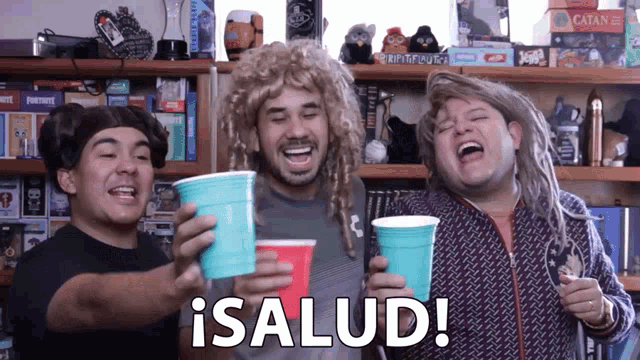 a group of people holding cups with the word salud written on it