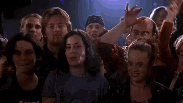a woman in a bc 110 shirt stands in a crowd