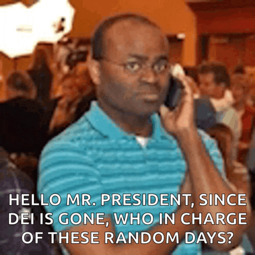 a man in a blue shirt is talking on his cell phone
