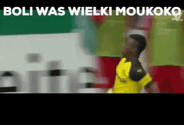 a blurred image of a soccer player with the words boli was wielki moukoko above him