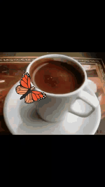 a cup of coffee on a saucer with a butterfly on it