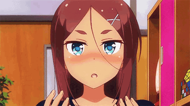 a girl with brown hair and blue eyes has a x on her head