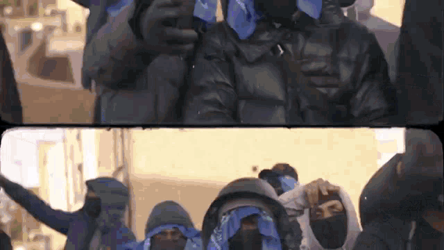 a group of people wearing face masks and bandanas are standing in a line .