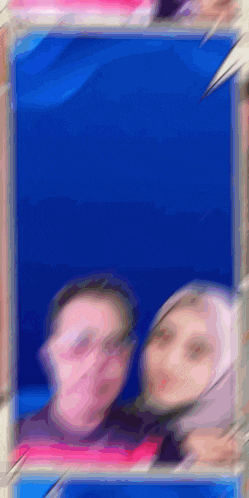 a blurry picture of a man and a woman standing next to each other