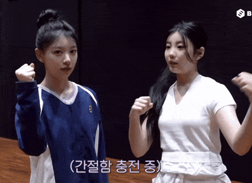 two girls are standing next to each other and one has a letter b on her jacket