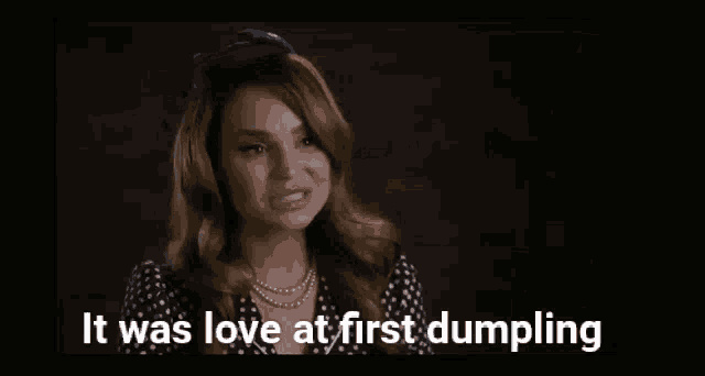 a group of people standing around a table with the words it was love at first dumpling